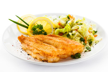 Fish dish - fried fish fillets and vegetable salad