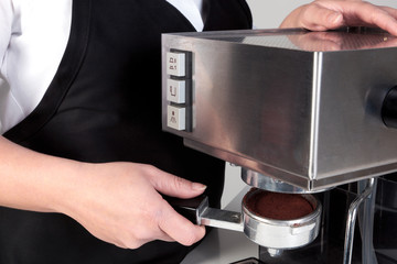Barista using an espresso machine.
