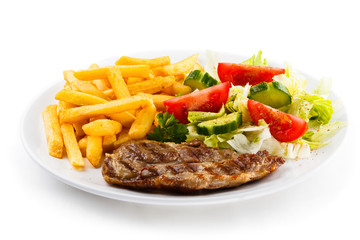 Grilled steak, French fries and vegetables