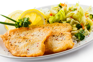 Fish dish - fried fish fillets and vegetable salad
