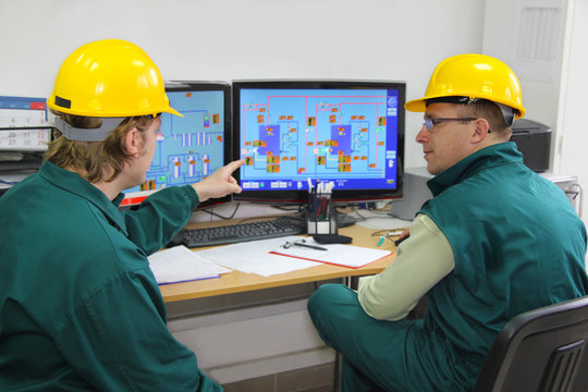 Industrial Workers In Control Room