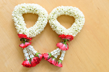 pair of thai style garland on wood background