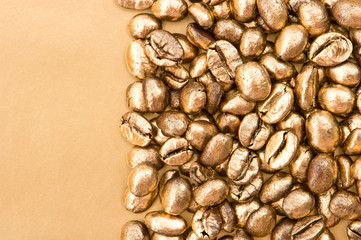 golden coffee beans on yellow background