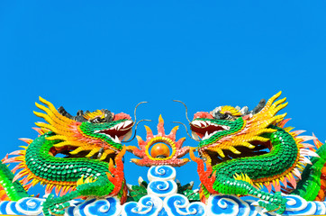 twin chinese dragon statue in blue sky