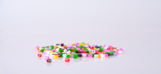 Play beads scattered on white background