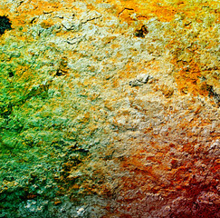 Rust background under a layer of clay with shades of green, red,