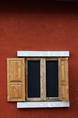 wood window on red wall