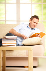 Man reading book in room