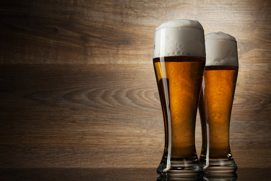 Two glass beer on wood background with copyspace