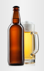 Beer into glass and bottle on a gray