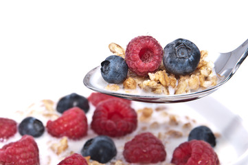 Muesli with fresh fruits on a spoon