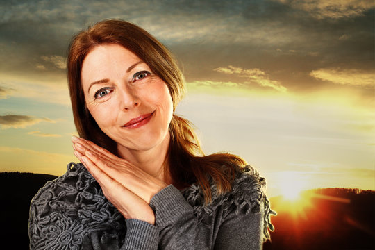 friendly smiling woman in the sunrise