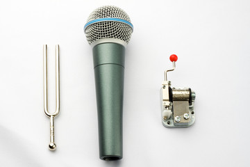 Music concept: pitchfork, a microphone and a carillon