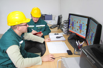 Industrial workers in control room