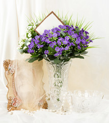 Beautiful spring flowers in a glass vase and frame
