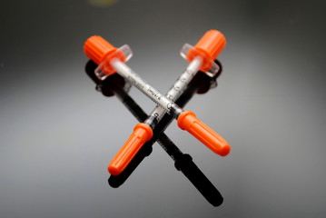 Disposible Syringes Over Black