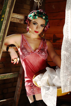 pin up girl on the attic in lingerie with curlers