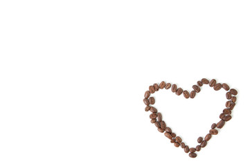 Coffee heart made of beans, white background, lots of copyspace