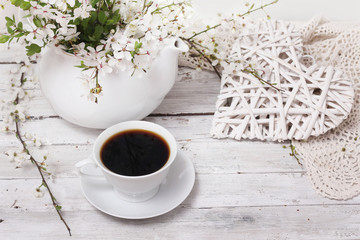 spring blossom, coffee and heart  on wood background