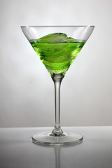 Green cocktail cup and ice