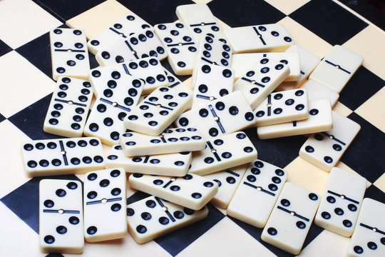 few domino on chessboard background