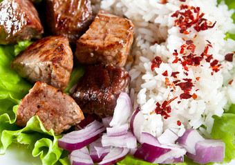 fried meat with rice and vegetables