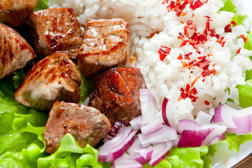fried meat with rice and vegetables