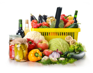 Plastic shopping basket and grocery isolated on white