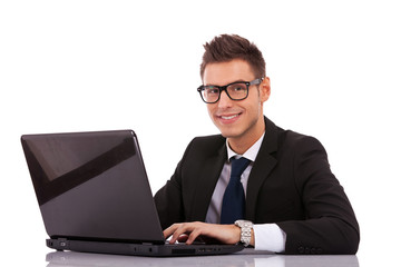 business man wearing glasses  using a laptop