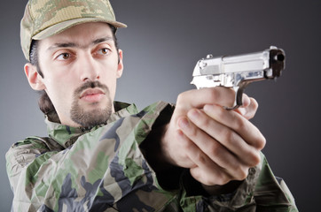Soldier with gun in studio shooting