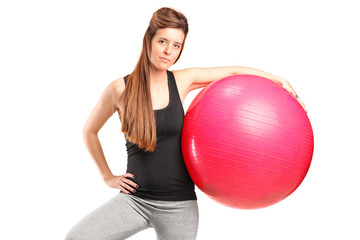 A portrait of a smiling female holding a fitness ball