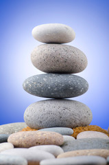 Fototapeta na wymiar Balanced pebbles with colour background