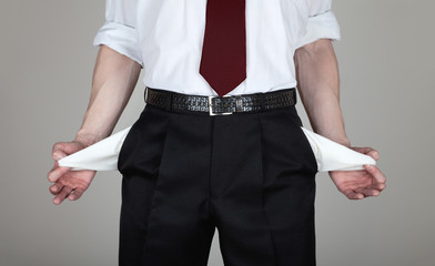 The businessman shows his empty pockets