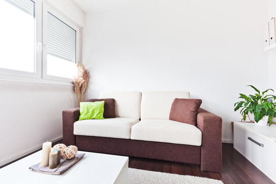 White and brown fabric sofa in the living room