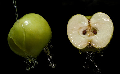 Fototapeta na wymiar green apple on a black background