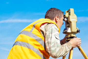 Surveyor engineer making measuring with theodolite