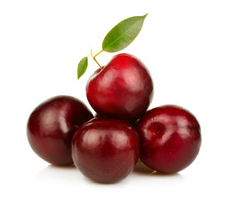 Heap of ripe plums fruits isolated on white