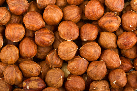 Heap of raw hazelnuts background