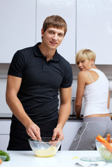 couple in their kitchen making dinner