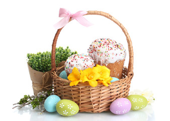 Beautiful Easter cakes, colorful eggs in basket and flowers