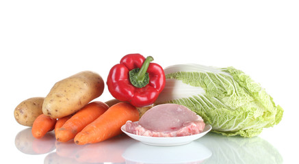 Fresh vegetables and pork steak isolated on white