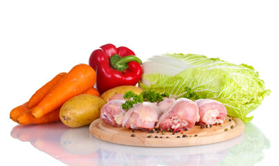 Fresh vegetables with raw chicken drumsticks and pork steak