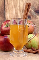 Apple cider with cinnamon sticks and apples.