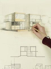 woman's hand drawing architectural sketch of house