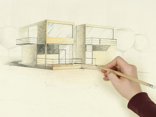 woman's hand drawing architectural sketch of house