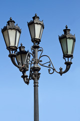 Fototapeta na wymiar Green street lamp with blue sky