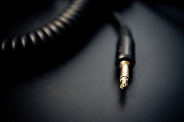 Macro of audio cable over dark background