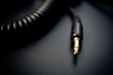 Macro of audio cable over dark background