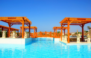 Luxury swimming pool and pergola in resort hotel