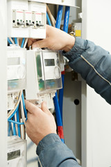 Close-up Electrician hands installing energy meter